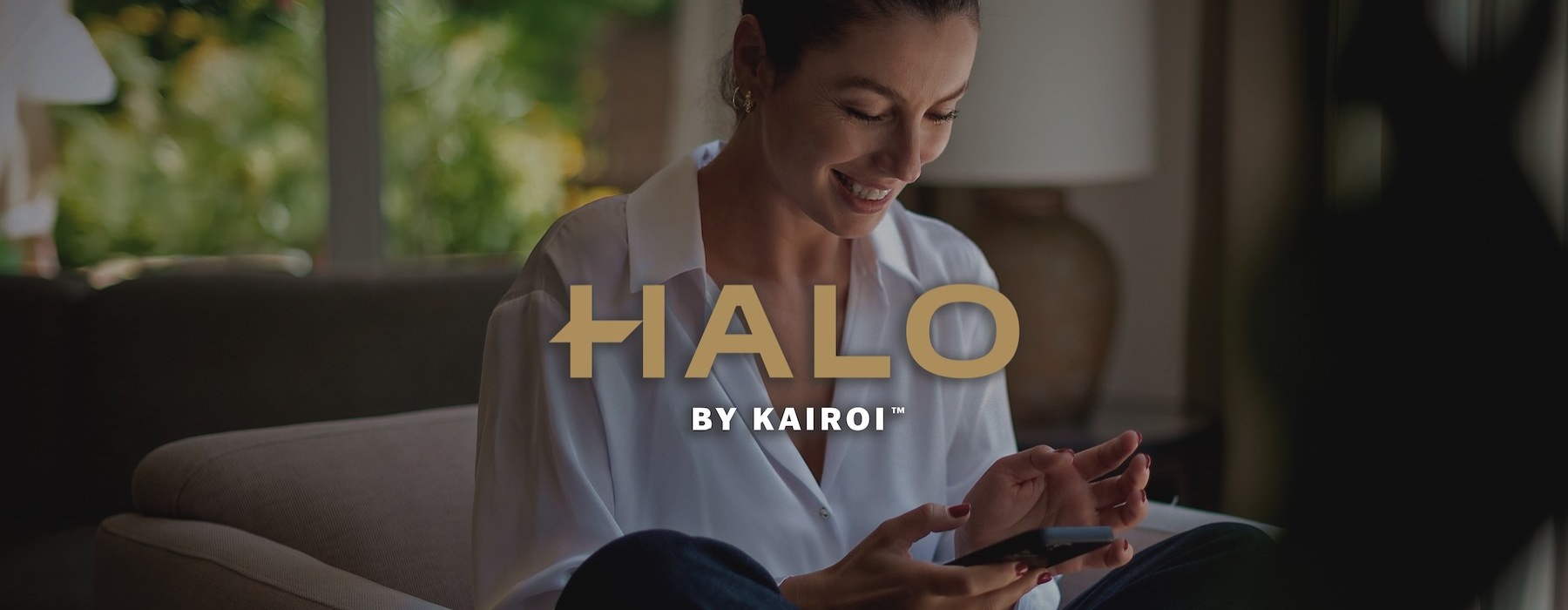 a woman smiling and interacting with her device